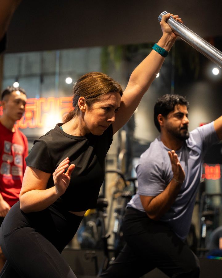 A client training with a barbell at the SHĀB studio
